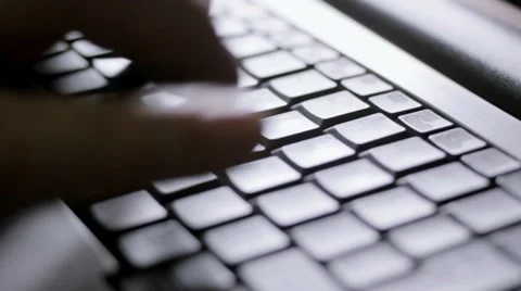 Typing on computer, backlit tracking shot Video stock 10738753