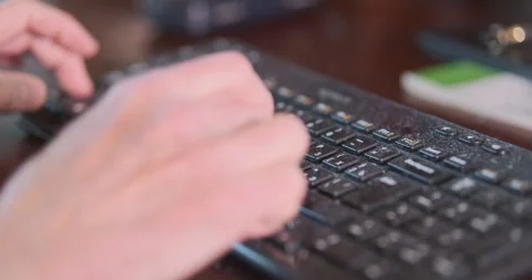Typing on a computer keyboard, close-up. An elderly man is typing on a computer. Vídeo Stock 241090356