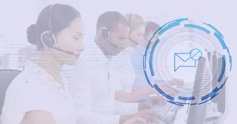 Typing at computer keyboards call center agents in office, with headsets and Stock Photos