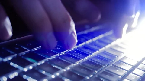 Typing on Computer Laptop in Slow Motion in the dark with blue Light Stock-Footage 124703940