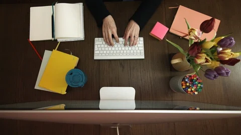 Typing at a computer in an overhead desk shot Stock Footage 107091813