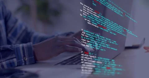 Typing developer's hands wearing blue plaid shirt pressing keys on laptop at Stock Photos