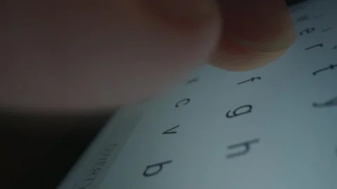 Typing on a Digital Touchscreen Device in a Dark Room Close Up 库存影片 331100810