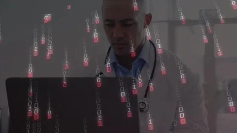 Typing doctor in lab coat with stethoscope at clinic laptop, binary overlay Stock Footage 332285329