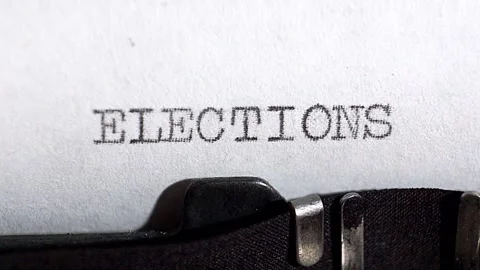 Typing ELECTIONS in black ink on an old vintage typewriter. Stock Footage 131472429