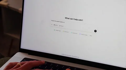 Typing 'Explain the weather patterns to me' into ChatGPT on a laptop Stock-Footage 302199320