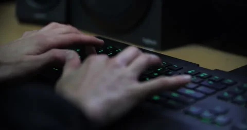Typing fast on mechanical black and green keyboard, coding programming Stock Footage 263415223
