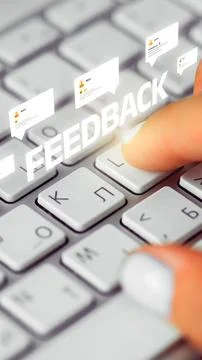 Typing feedback on a computer keyboard with digital comment bubbles appearing Stock Photos