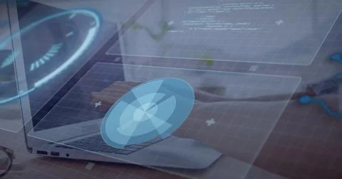 Typing female hands navigating blue holographic interface on silver laptop at Stock Photos
