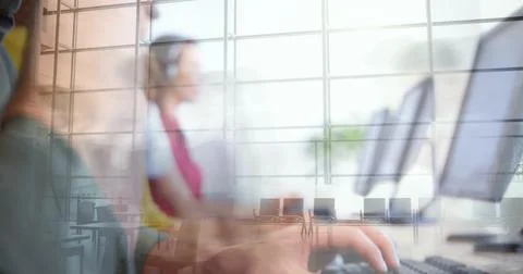 Typing foreground hand and headset worker using keyboard at desk in computer Stock Photos