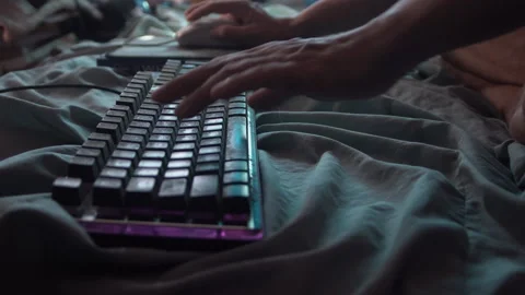 Typing gaming keyboard on bed. 스톡 동영상 156834475