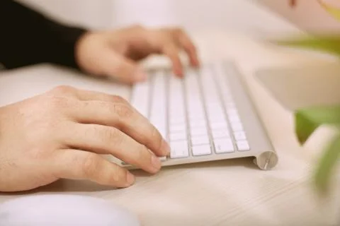 Typing hands on a keyboard Stock Photos