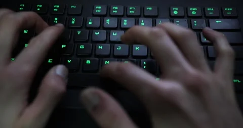 Typing with hands on mechanical keyboard green light,  coding writing Stock Footage 263408467