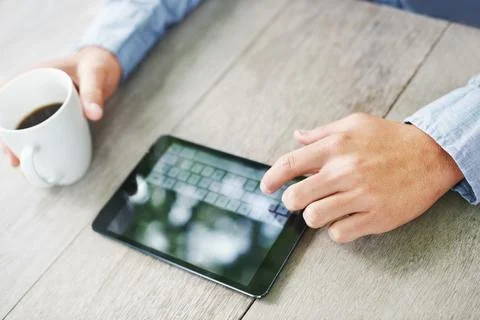 Typing in his selection. Cropped view of a mans hands using a digital tablet Stock Photos