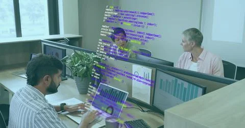 Typing Indian developer tapping laptop keyboard in office, with monitors, coffee Stock Photos