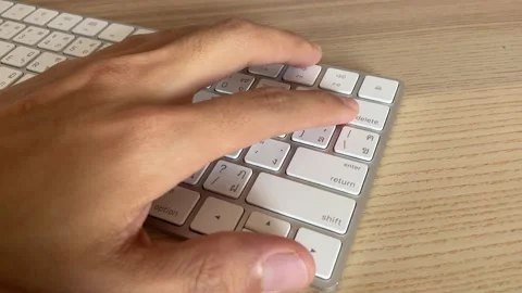 Typing on keyboard. Finger pressing "delete" button key on English - Thai button Stock Footage 186986945