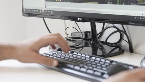 Typing on a keyboard. Man using mouse and typing on computer keyboard. Stock Footage 99996744