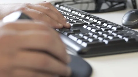Typing on a keyboard. Man using mouse and typing on computer keyboard. Stock Footage 99997131