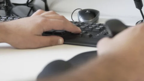 Typing on a keyboard. Man using mouse and typing on computer keyboard. Stock Footage 99997175