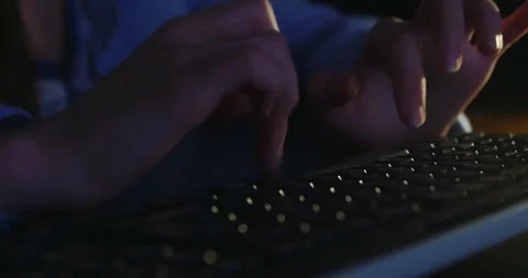 Typing on keyboard at night. Dark background lighting. Close-up Stock Footage 98708252