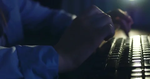 Typing on keyboard at night. Dark background lighting. Close-up Stock Footage 98818628