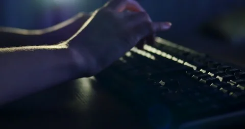 Typing on keyboard at night. Dark background lighting. Close-up Video stock 99010614