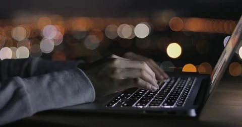 Typing on laptop computer at night Stock Footage 79024380