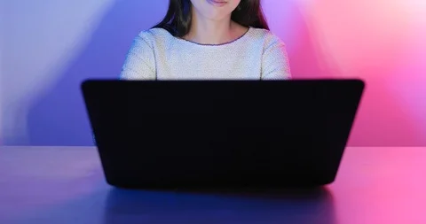 Typing on laptop computer with red and blue light Video stock 89482559