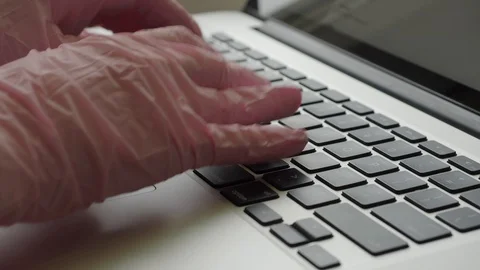 Typing on laptop in gloves Stock Footage 127576193