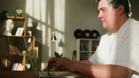 Typing on laptop keyboard close-up. Man with blue hair working in office Stock Footage 178608723