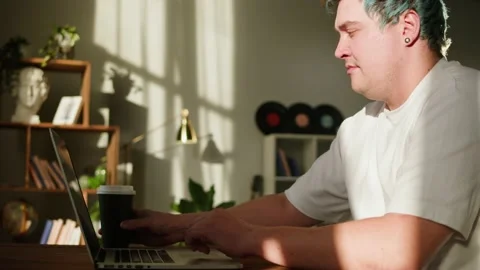 Typing on laptop keyboard close-up. Man with blue hair working in office and 스톡 동영상 180548798