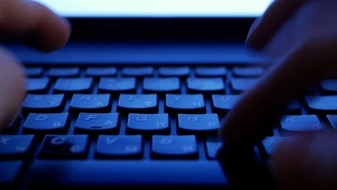 Typing on a laptop keyboard during night Stock Footage 100818525
