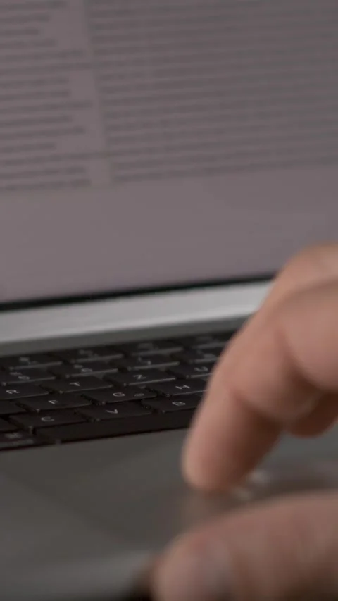Typing on a laptop keyboard with focus on fingers and screen content Stock Footage 337229784
