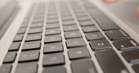 Typing on a laptop keyboard isolated Stock Footage 104957802