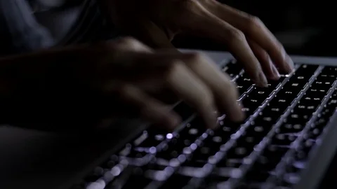 Typing on laptop keyboard at night Stock Footage 80018993