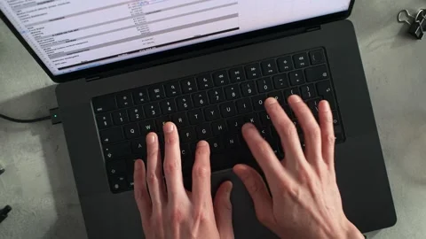 Typing on a Laptop Keyboard Office Worker Entering Data into a Spreadsheet Stock Footage 286239907