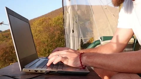 Typing on laptop in the mountain Stock Footage 235886418