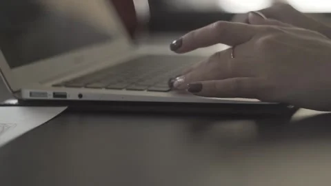 Typing on a laptop. They work in the office. Work in the office. Stock Footage 130225552