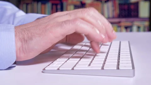 Typing in the library  Video stock 147750377
