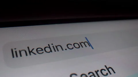 Typing LinkedIn domain in browser bar - Macro Stock Footage 145645144