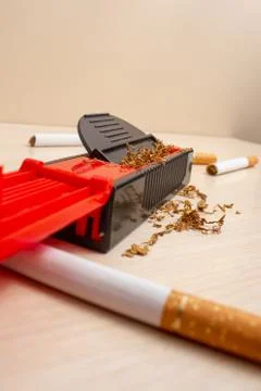 Typing machine and cigarettes in the background on a light wooden Stock Photos