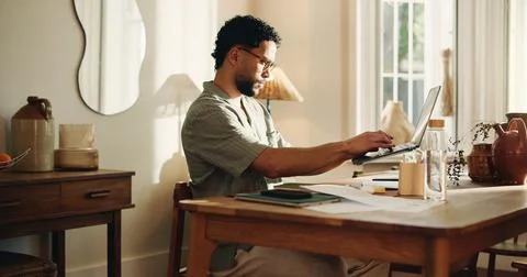 Typing, man and creative with laptop, home and research for logo design on .. Stock Photos