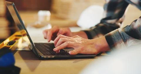 Typing, man and hands of carpenter with laptop in workshop for research on Stock Photos
