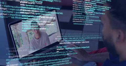 Typing man in blue reclining on bed, using laptop showing white T-shirt caller Photos