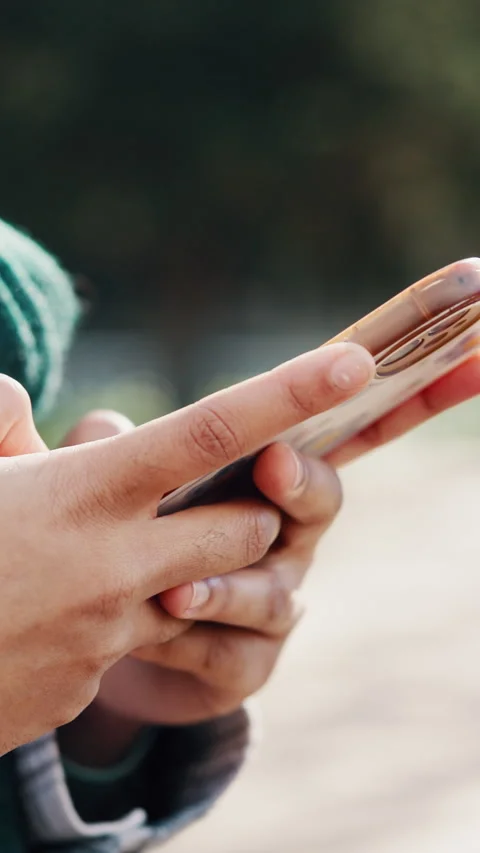Typing, message and hands with phone at park, online and communication with Stock Footage 338064320