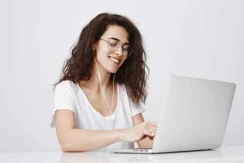 Typing message to answer on tricky question from friend. Pleased happy young Stock Photos