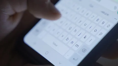 Typing a message from the close-up phone keyboard. Stock Footage 219713288