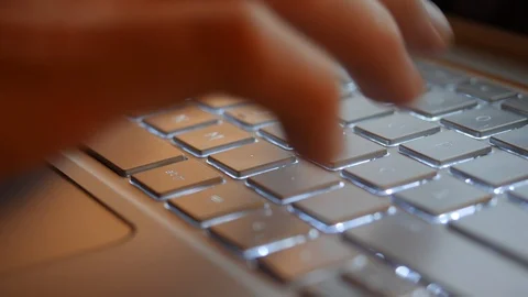 Typing on modern Laptop Computer at night in Slow Motion Stock Footage 124703154