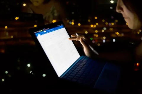 Typing notebook working on screen at night Stock Photos