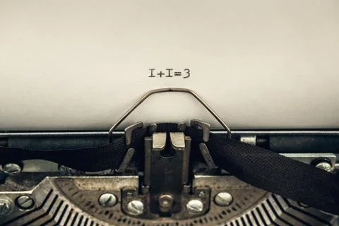 Typing numerals 1 plus 1 equally 3 on a vintage typewriter close-up. concept  写真素材